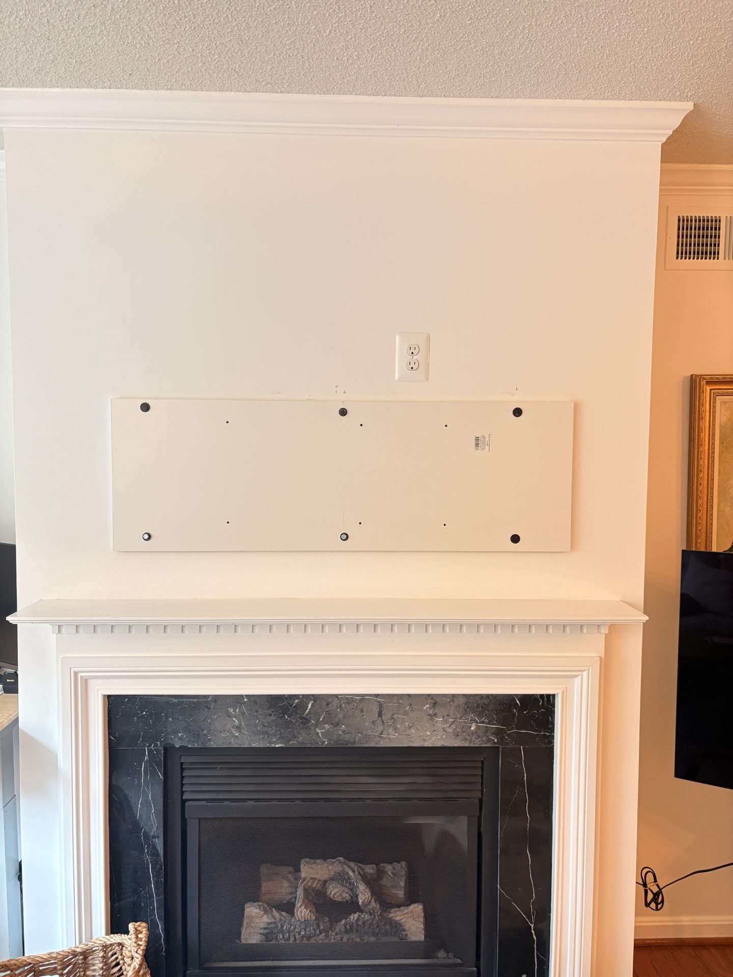 Fireplace wall inspected before pull-down TV mounting in Arlington VA