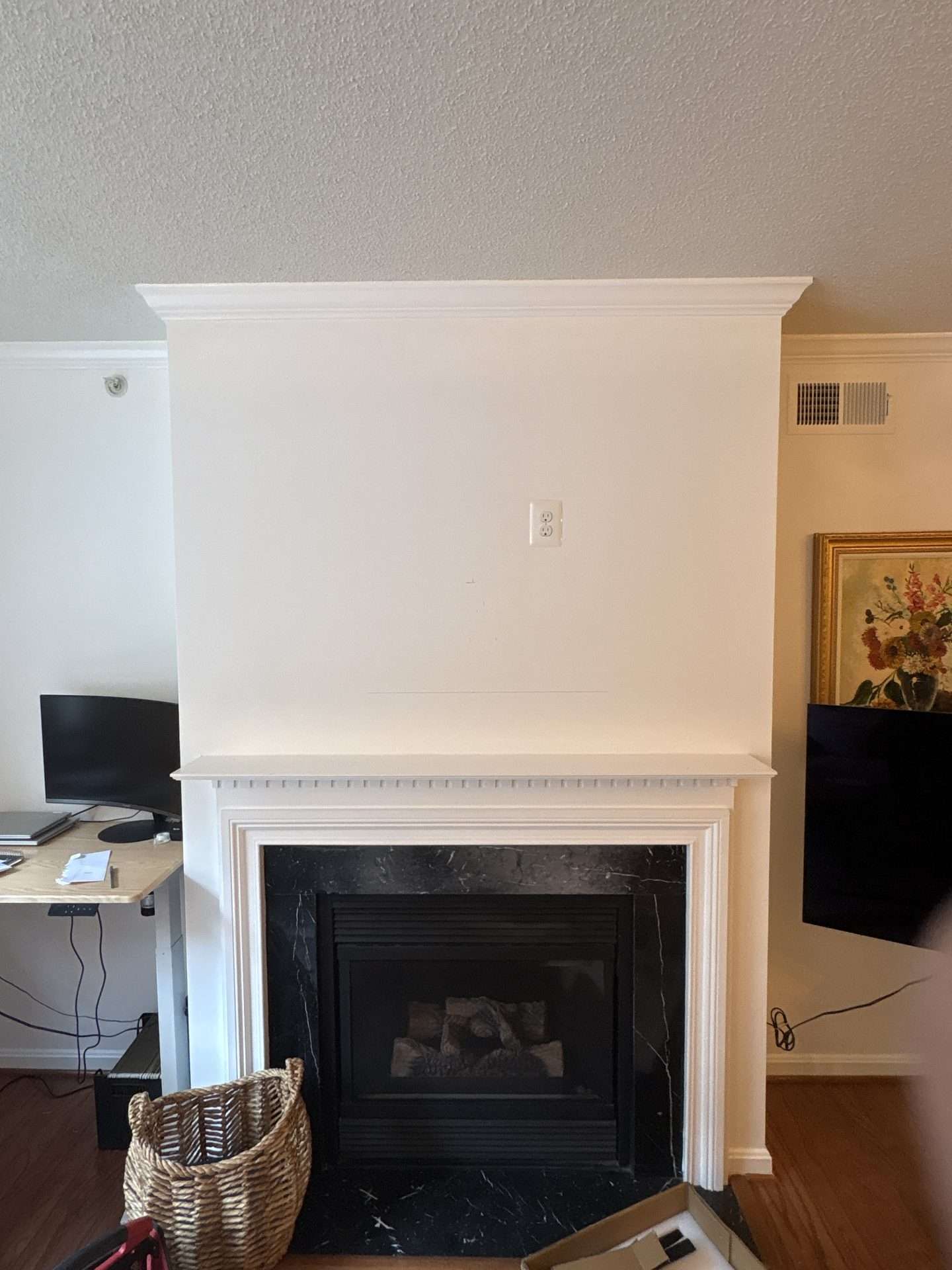 55-inch pull-down TV mounted over fireplace in Arlington Virginia